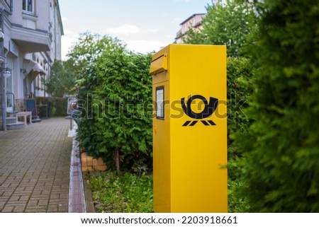 yellow mailbox on the street