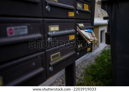 newspapers in the mailbox on the street