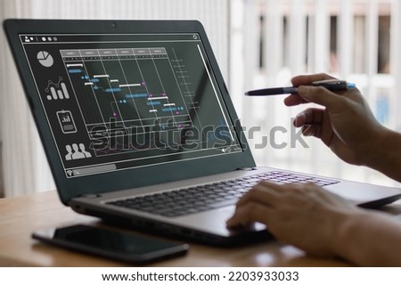 Corporate strategy for finance, operations, sales, marketing. Analyst working with computer in Business Analytics and Data Management System to make report with KPI and metrics connected to database. Royalty-Free Stock Photo #2203933033