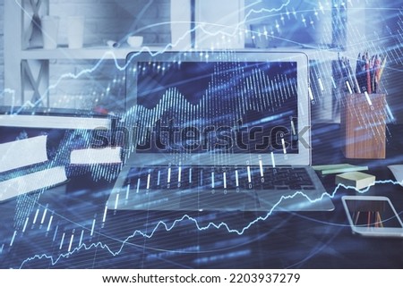 Forex market graph hologram and personal computer on background. Double exposure. Concept of investment.