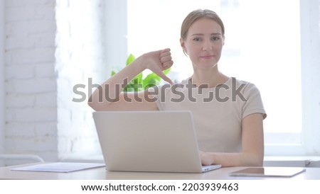 Thumbs Down by Woman Working on Laptop