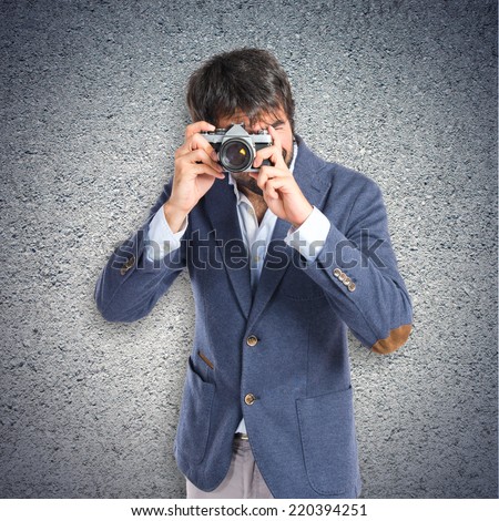 Man photographing over textured background 