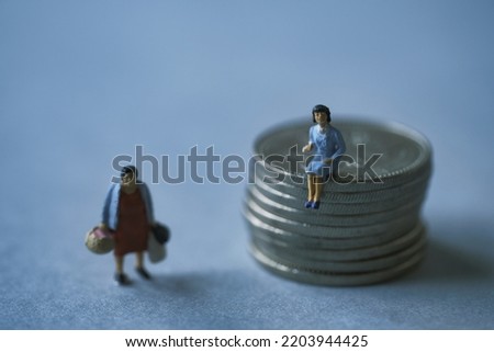 Miniature woman sitting on Japanese coins