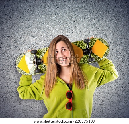 Skater with green sweatshirt over textured background 