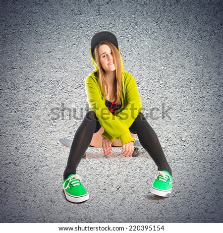 Pretty young girl wearing urban style over textured background 