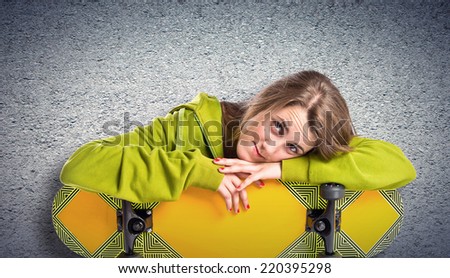 Blonde girl with skate over textured background 