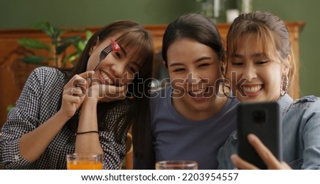 Small girl group party asia people busy talk smile eat brunch food drink. Young woman fun happy hour meal shoot photo of dish plate salad bowl on table post app in vegan cafe bar shop.