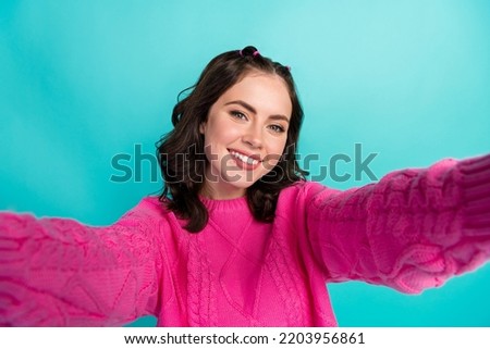 Portrait of cute lovely attractive girl with tails hairstyle dressed pink knit jumper making selfie isolated on turquoise color background