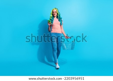 Full body photo of young social media influencer female go to grocery store isolated on blue color background