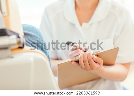 Asian female nurse and patient (dentist) Royalty-Free Stock Photo #2203961599