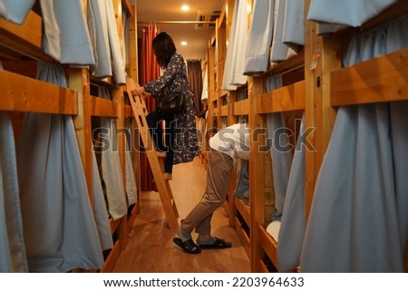 People using their room at a hostel in Japan Royalty-Free Stock Photo #2203964633