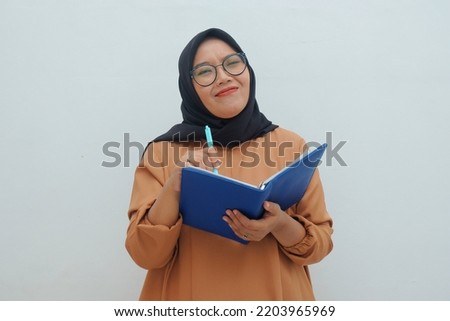 sad expression of muslim woman while holding book