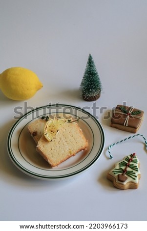 Homemade Lemon cake decorated with cookie for party. Tasty dessert for winter holidays. Merry Christmas and Happy New Year atmosphere.