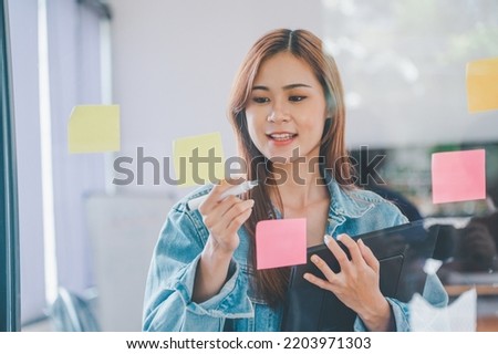 Web designers creating planning and analyzing with Colorful sticky notes on the office board.web design concept