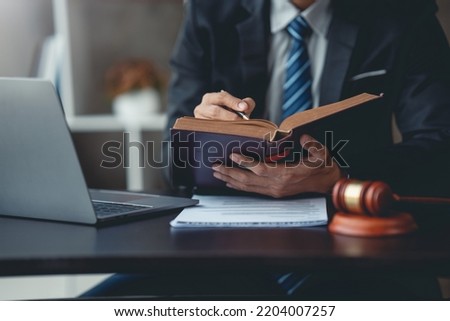 Businessman and lawyer look at contract terms in law, discuss contract document. Treaty Law. Signing a business contract, signing important document.