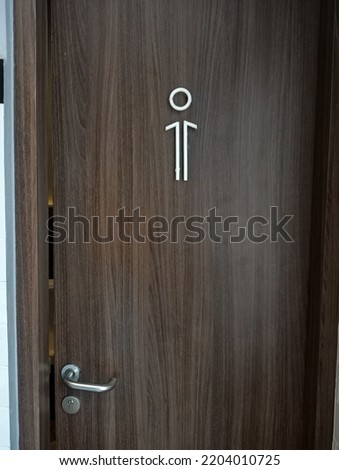 men's toilet logo in front of the door