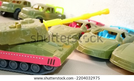 Used, broken or damaged vintage retro toy cars, tanks, tractors. Lots of toy cars to play beside Childhood concept.