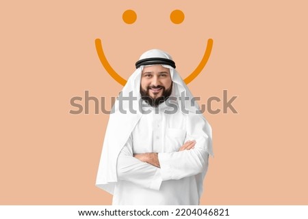 Muslim man and drawn smile on beige background