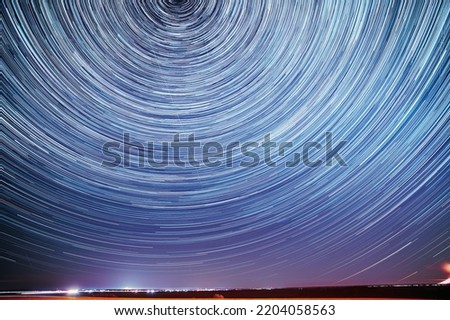 Unusual Amazing Stars Effect In Sky. Trace Of Moon. Spin Of Star And Meteoric Trails On Night Sky. Moonrise Sky Natural Background. Large Exposure. Imagination, Fantasy, Illusion, Dream View. Flight