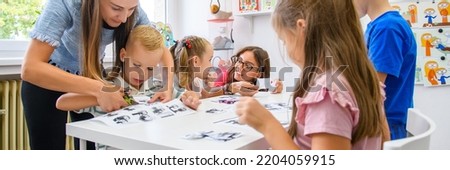 Child occupational therapy session. Group of children doing playful exercises with their therapist.  Royalty-Free Stock Photo #2204059915