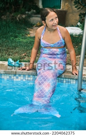 a girl in a mermaid costume