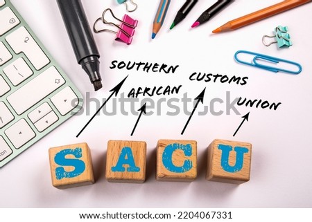 SACU - Southern African Customs Union. Wooden blocks on a white office table.