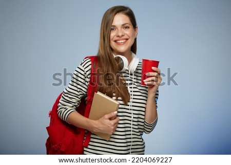 Young adult student millennial woman with book and red backpack holding red coffee cup. Isolated female portrait.