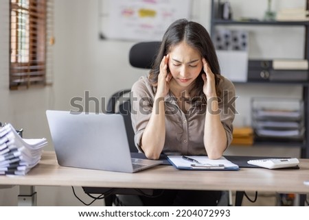 Asian indian women are stressed while working on laptop, Tired asian businesswoman with headache at office, feeling sick at work copy space in workplace an home office. Royalty-Free Stock Photo #2204072993