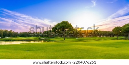 Panorama of dawn over a golf course with a pine forest in the background in Belek Turkey Royalty-Free Stock Photo #2204076251