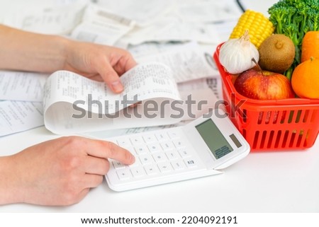 Calcuating household expenses, cost of living and inflation concept Royalty-Free Stock Photo #2204092191
