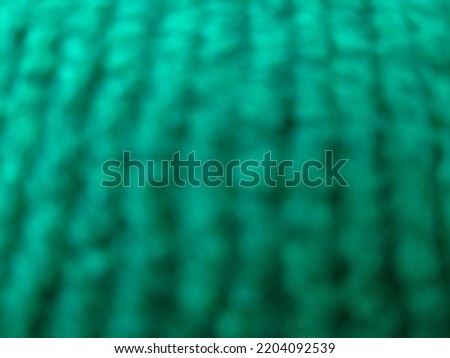 blurry defocused background of green carpet. Great for wallpaper.