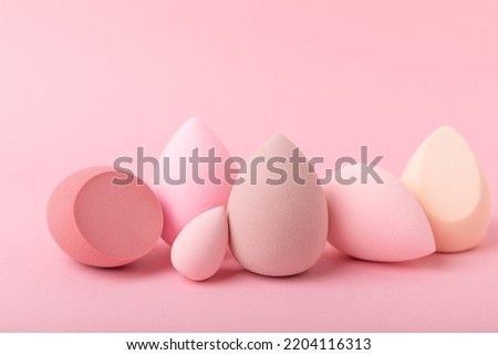 Beauty blender on a pink background.Bright sponges for make-up cosmetics. Makeup products. Beauty concept. Place for text. Space for copy. Flat lay Royalty-Free Stock Photo #2204116313