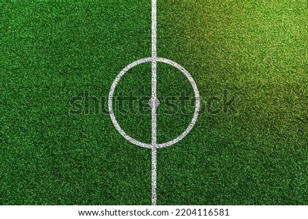 Top view of soccer field center with white lines pattern. Royalty-Free Stock Photo #2204116581