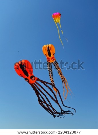 Three Octopus Kites against blue sky  