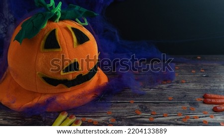 funny halloween pumpkin with candy on a dark background