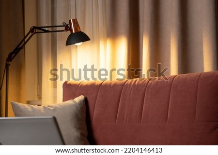 The lamp in the living room turns on and off Royalty-Free Stock Photo #2204146413