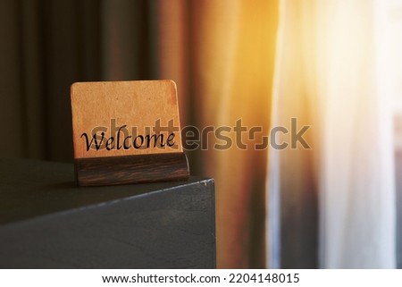 welcome sign on table with sun