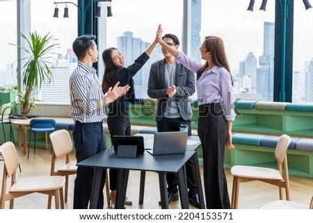 Team of young Asian entrepreneurs and startup have business meeting and encouraging each other for good energy to accomplish successful marketing plan concept Royalty-Free Stock Photo #2204153571