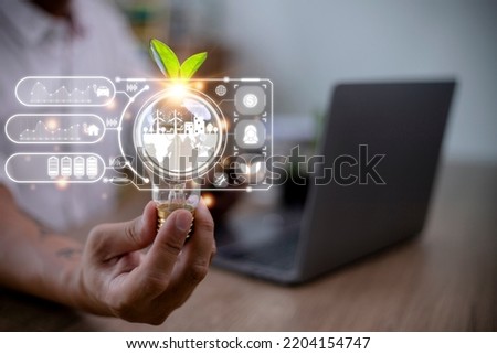 Businesswoman hand holding light bulb with esg icon on virtual screen, ESG Environmental, social and corporate governance concept
