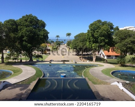 A beautifiul view from the park and its trees receiving the latest sunbeams from the winter.  The park is called João Hélio and its located in the city of Araruama, RJ Brazil. Royalty-Free Stock Photo #2204165719