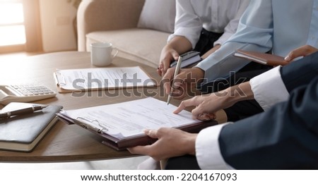 Real estate agent explaining and let customers sign a house purchase contract, discussing for contract to buy house, real estate concept and background.
