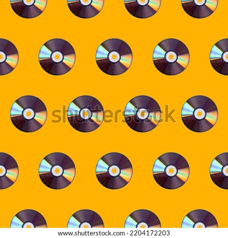 Seamless pattern of CD disks on a yellow background. Retro gadgets.