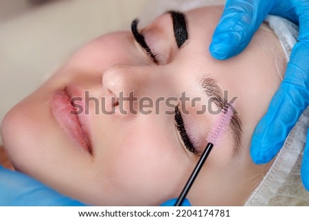 Beauty and Healthy Lifestyle Ideas. Young Beautiful Woman Having Permanent Make-up Tattoo on Eyebrows in beauty Salon.Horizontal image