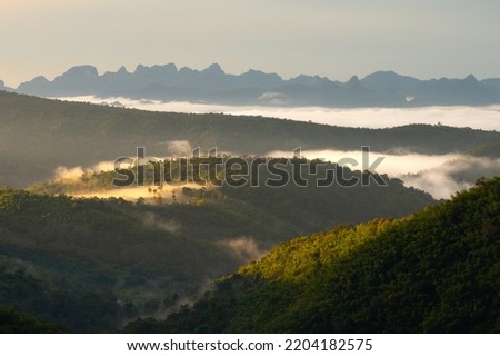 A picture of a beautiful mountain in the morning with fog and sunlight in Nam Nao District. Phetchabun Province, Thailand.