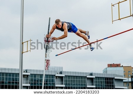 male athlete unsuccessful attempt pole vault Royalty-Free Stock Photo #2204183203