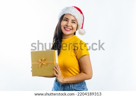 Attractive excited asian woman wear Santa Clause christmas hat and holding new year gift box, isolated on background.