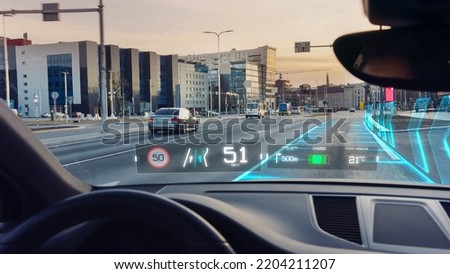 Futuristic Autonomous Self-Driving Car Moving Through City, Head-up Display HUD Showing Infographics: Speed, Distance, Navigation. Road Scanning. View From Driver Seat  First Person View FPV.