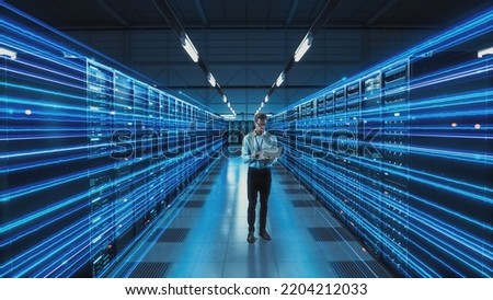 Futuristic 3D Concept: Big Data Center Chief Technology Officer Holding Laptop Standing In Warehouse, Information Digitalization Lines Streaming Through Servers. SAAS, Cloud Computing, Online Service Royalty-Free Stock Photo #2204212033