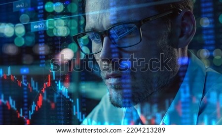 Stock Market Trader Working with Investment Charts, Graphs, Ticker Numbers Projected on Face and Reflecting in Glasses. Financial Analyst, Digital Entrepreneur doing Social Trading with an App. Royalty-Free Stock Photo #2204213289