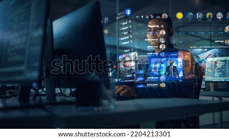 Hologram Screens: Creative Indian Man Using Desktop Computer with Holographic Projection, Multiple Displays Show Websites, Video Streaming Services, Social Media Feed, e-Commerce, e-Learning Content Royalty-Free Stock Photo #2204213301